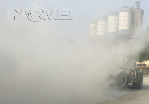 A ready mix concrete batching plant immersed in flying dust